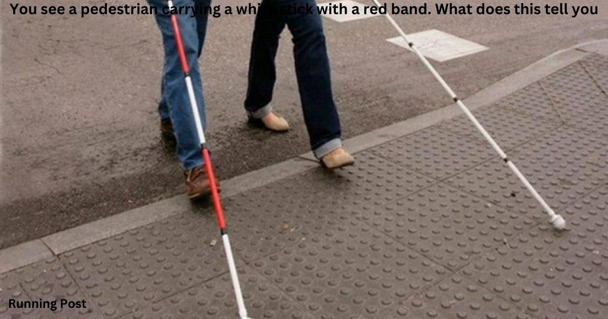 You see a pedestrian carrying a white stick with a red band. What does this tell you