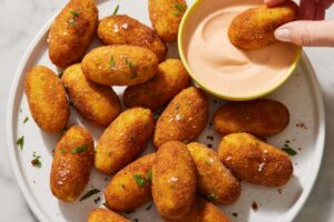 Delicious Appetizers Like Croquetas and Patatas Bravas